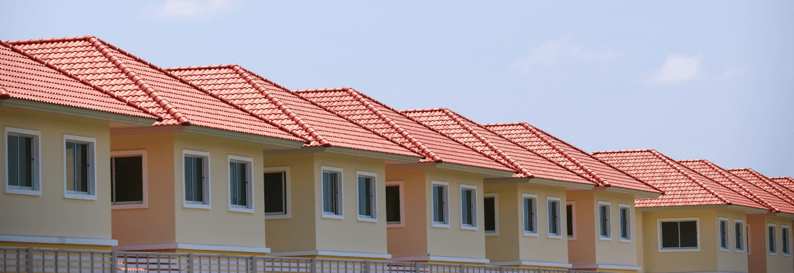 A row of newly built houses with red tiled roofs