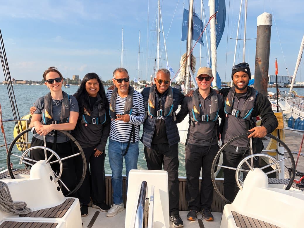The team lined up between the twin helms in matching sailing jackets before casting off.